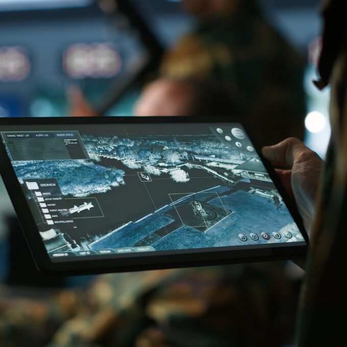 Military agent working in control room, using software on tablet Military agent working in control room, using software on tablet